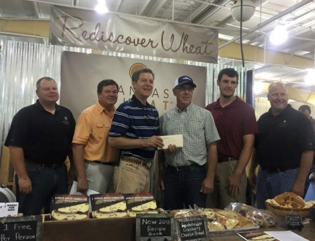 Darwin Ediger receives the Wheat Quality Initiative Award from Governor Sam Brownback at the Kansas State Fair.