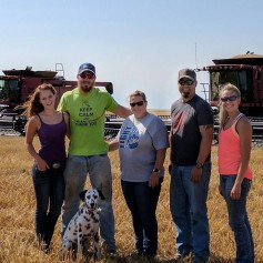 Cassidy Kreigh poses with the Schemm family during 2017 wheat harvest.