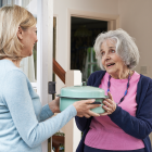 woman-delivering-food-to-elderly-neighbor.png
