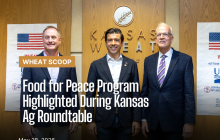 Congressman Mann, Under Secretary Lindberg and Senator Moran standing in front of the Kansas Wheat sign following the press conference.