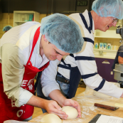 Photo: USW's Luke Muller and NAWG's Keeff Felty bake bread in the baking lab.