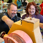 Photo: Chris Tanner and April Darnell set their mill in the KSU Grain Science milling lab.