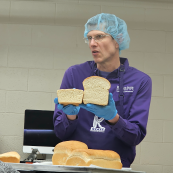 Photo: Baking instructor Aaron Clanton shows the difference between loaves of bread made with different classes of wheat.