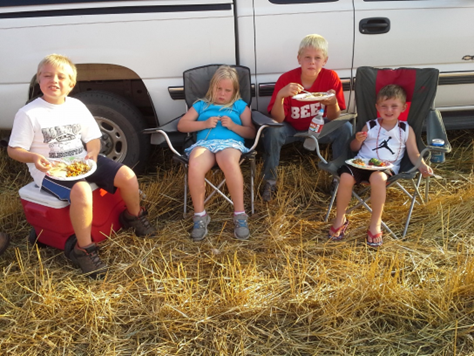 Photo: Kids with meals in wheat field.