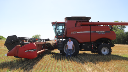 Randy Fritzemeier stands in front of his combine during his final wheat harvest in 2022.