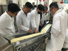 Better Wheat…Better Ramen. USW and the Wheat Marketing Center (WMC) held a Noodle Workshop for Korean manufacturers in June to test several blends of U.S. wheat flour for ramen noodle production. Here the participants are observing ramen on the WMC pilot 